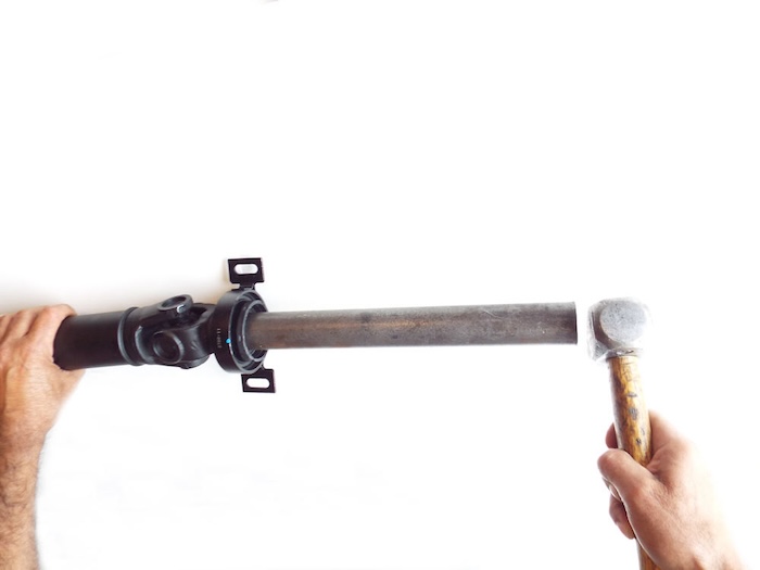 using a hammer to drive the center support into place