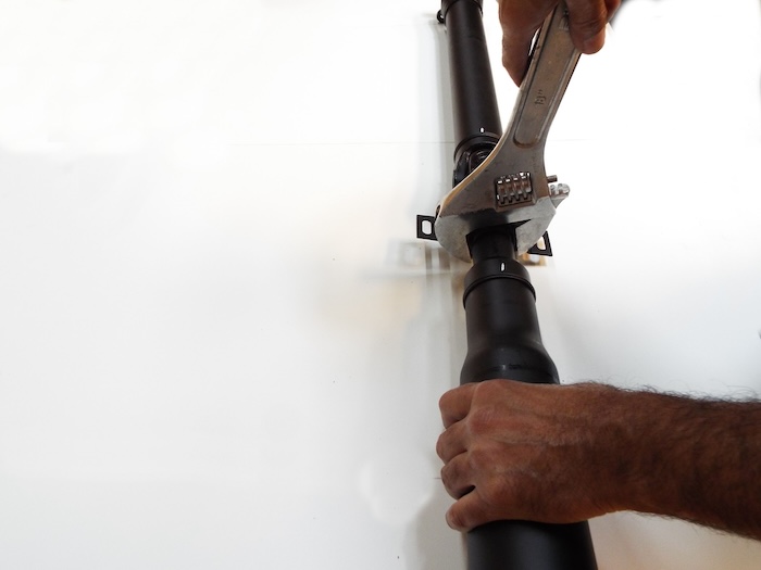 opening the bmw driveshaft locking nut using a crescent wrench