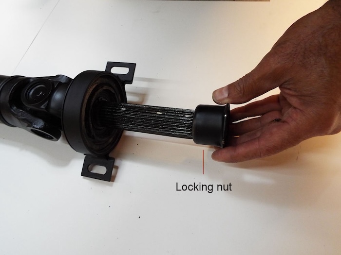 pulling the locking nut and showing the marking on the driveshaft spline